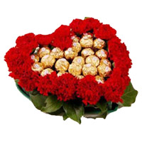 Diwali Flowers Delivery in India. 24 Red Carnation Flowers with 24 Ferrero Rocher Chocolate to India in Heart Arrangement