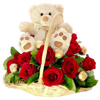 Send Diwali Gifts to India containing 12 Red Roses, 10 Ferrero Rocher Chocolates and 9 Inch Teddy Basket on Diwali