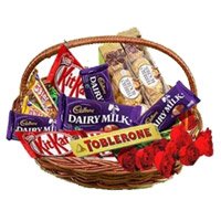 Send Deepawali Flowers to India. Basket of Assorted Chocolate and 10 Red Roses to Delhi